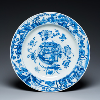 A large Chinese blue and white dish with raised central medallion, Kangxi