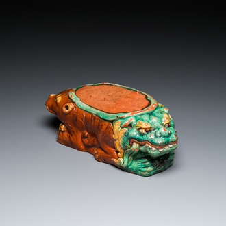 A Chinese sancai-glazed 'three lions' pillow or neck rest, Ming