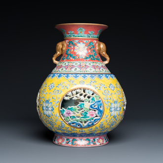 A Chinese reticulated and revolving famille rose vase consisting of two parts, Qianlong mark, 20th C.