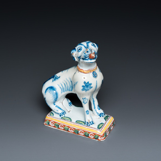 A polychrome Dutch Delft dog seated on a plinth, 18th C.