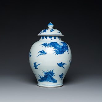A Chinese blue and white covered vase with birds among blossoming branches, Transitional period