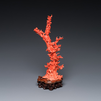 A Chinese red coral sculpture of Xiwangmu standing on a rock, 19/20th C.