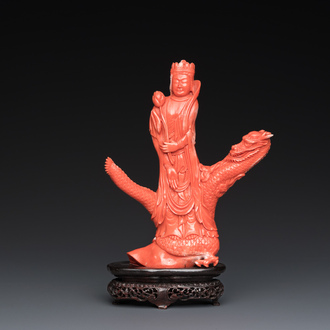 A Chinese red coral group of a standing prince on a dragon, 19/20th C.