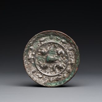 A Chinese silvery bronze 'lion and grapevine' mirror, Tang