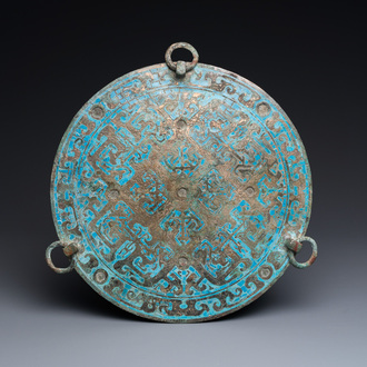 A large Chinese bronze mirror with turquoise and gold or gilt silver inlays, Warring States Period