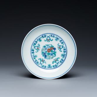 A Chinese doucai saucer with floral design, Yongzheng mark, 19/20th C.