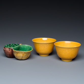 A Chinese sancai-glazed water dropper and a pair of yellow-glazed anhua 'dragon' bowls, Xianfeng mark, Kangxi and later