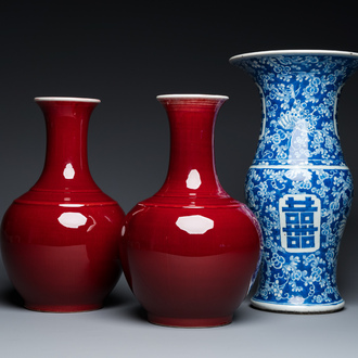 A Chinese blue and white 'Shou' vase with butterflies and a pair of sang-de-boeuf-glazed bottle vases, 19/20th C.