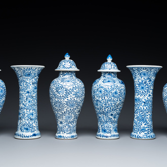 A Chinese blue and white garniture of six vases with floral design, Kangxi