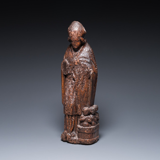 A Flemish carved oak sculpture of Saint Nicolas and the three boys in the salting-tub, 16th C.