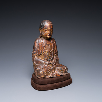 A Chinese gilt-lacquered wood sculpture of an Arhat, Ming