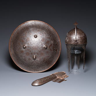 A Qajar tinned copper helmet (khula khud), shield (dhal) and arm piece (dastana), Persia, 19th C.