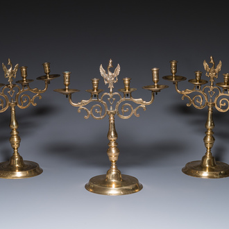 Three large Polish or Prussian bronze 'shabbat' candlesticks crowned with double eagles, 17th C.