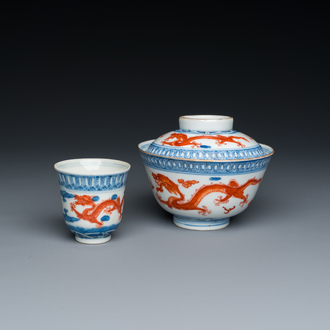 A Chinese blue, white and iron-red 'dragon' bowl and cover and a wine cup, Qianlong mark, 18/19th C.