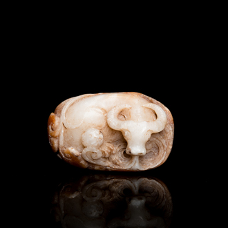 A Chinese white and russet jade 'buffalo' pendant, 19th C.