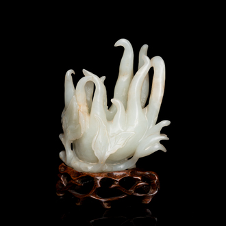 A fine Chinese white jade carving of a Buddha's hand on wooden stand, Qing