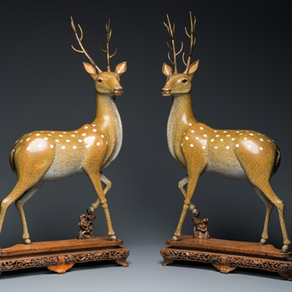 A very fine and large pair of Chinese cloisonné models of deer on reticulated wooden stands, 19th C.