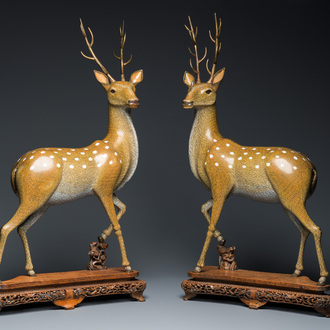 A very fine and large pair of Chinese cloisonné models of deer on reticulated wooden stands, 19th C.