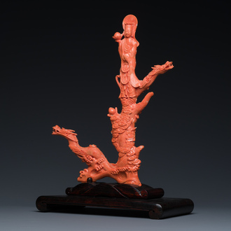 A Chinese red coral figure of a standing Bodhisattva with two dragons, 19/20th C.