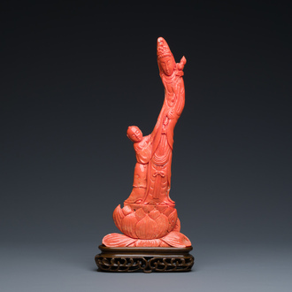 A Chinese red coral group of a standing Guanyin with a boy on a lotus flower, 19/20th C.