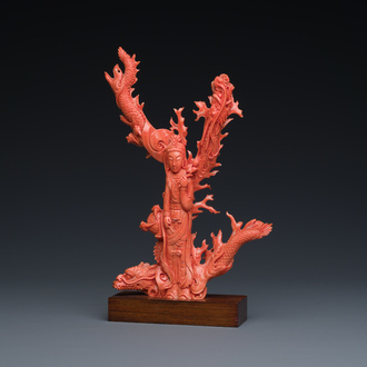 A Chinese red coral figure of a standing Guanyin with a dragon, 19/20th C.