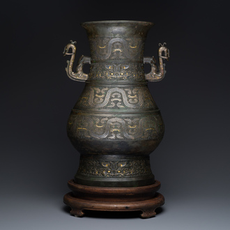 An imposing Chinese archaic gold-and-silver-inlaid bronze 'hu' vase on wooden stand inscribed Tao Xiang 陶湘 and Luo Zhenyu 羅振玉, Song/Ming