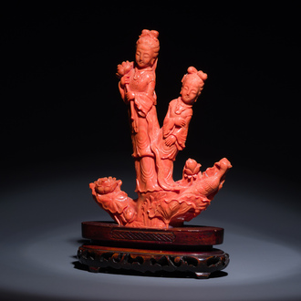 A Chinese red coral group of two standing ladies with lotus flowers, 19/20th C.
