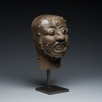 A Tibetan cast iron 'Mahakala' mask, 16/17th C.