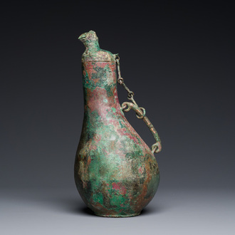 A rare archaic Chinese bronze gourd-shaped vase and cover, 'hu', Eastern Zhou