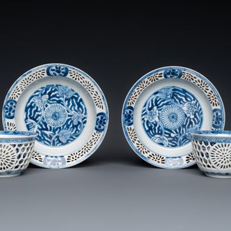 A pair of Chinese blue and white reticulated double-walled cups and saucers, Kangxi