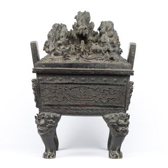 A large Chinese bronze censer and cover with a dragon in a rocky landscape with various animals, Yuan