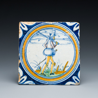 A polychrome Dutch maiolica medallion tile with a soldier, late 16th C.
