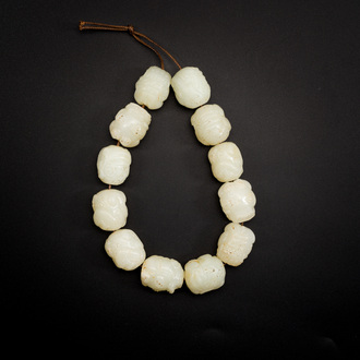 A Chinese white jade 'Buddhist lion' beads bracelet, Qing