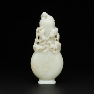 A fine Chinese white jade 'buddhist lions' vase and cover, Qing