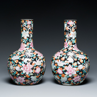A pair of Chinese famille rose black-ground millefleurs bottle vases, Qianlong mark, Republic