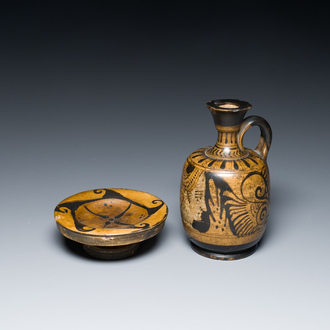 An Etruskian 'aryballos' portrait ewer and a 'patera' dish with black geometrical design, 4th C. b.C.