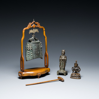 A Chinese bronze bell and two figures, Ming and later