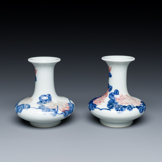 A pair of Chinese blue, white and copper-red vases with floral design, Qianlong mark, 19/20th C.