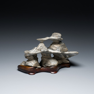 A Chinese grey lingbi stone scholar's rock on wooden stand, 19/20th C.