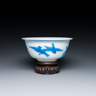 A fine Chinese overlay Beijing glass bowl with birds and flowers in blue on white, 19/20th C.