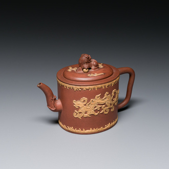 A Chinese Yixing stoneware teapot and cover with an applied dragon, Kangxi