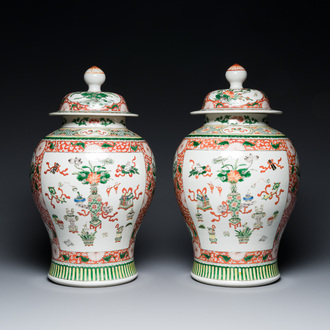 A pair of Chinese famille verte 'antiquities' vases and covers, 19th C.