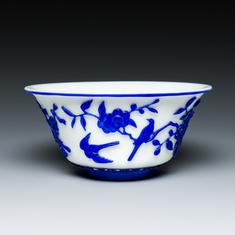 A Chinese overlay Beijing glass 'magpie and plum blossom' bowl in blue on white, 19th C.
