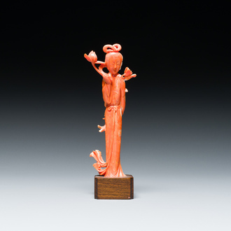 A Chinese red coral figure of a lady with a lotus flower, 19/20th C.