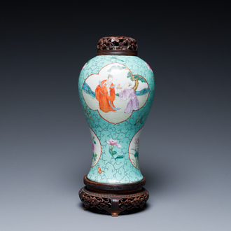 A Chinese turquoise-ground famille rose vase with reticulated wooden cover and stand, 1st half 19th C.