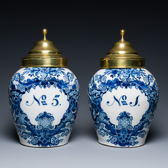 A pair of Dutch Delft blue and white tobacco jars with brass covers, 18th C.