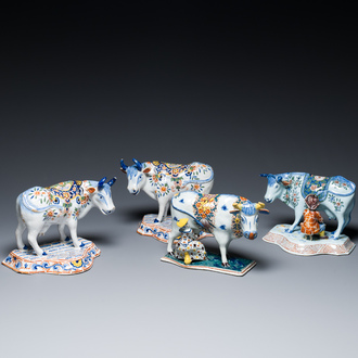 A pair of polychrome Dutch Delft cows and two 'milking' groups, 18/19th C.
