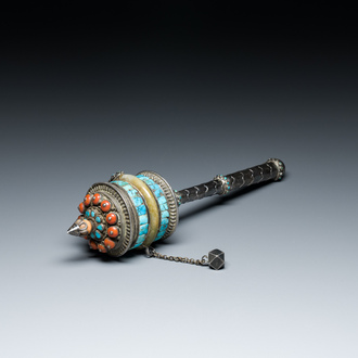 A Tibetan silver prayer wheel with turquoise and coral inlay, 19th C.
