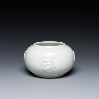 A Chinese white-glazed relief-molded bowl, Qianlong mark, 19th C.