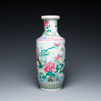 A Chinese famille rose rouleau vase with a parrot among blossoming branches, 19th C.